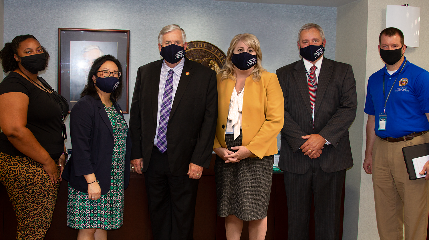 Group photo of DOLIR employees with Governor Parson